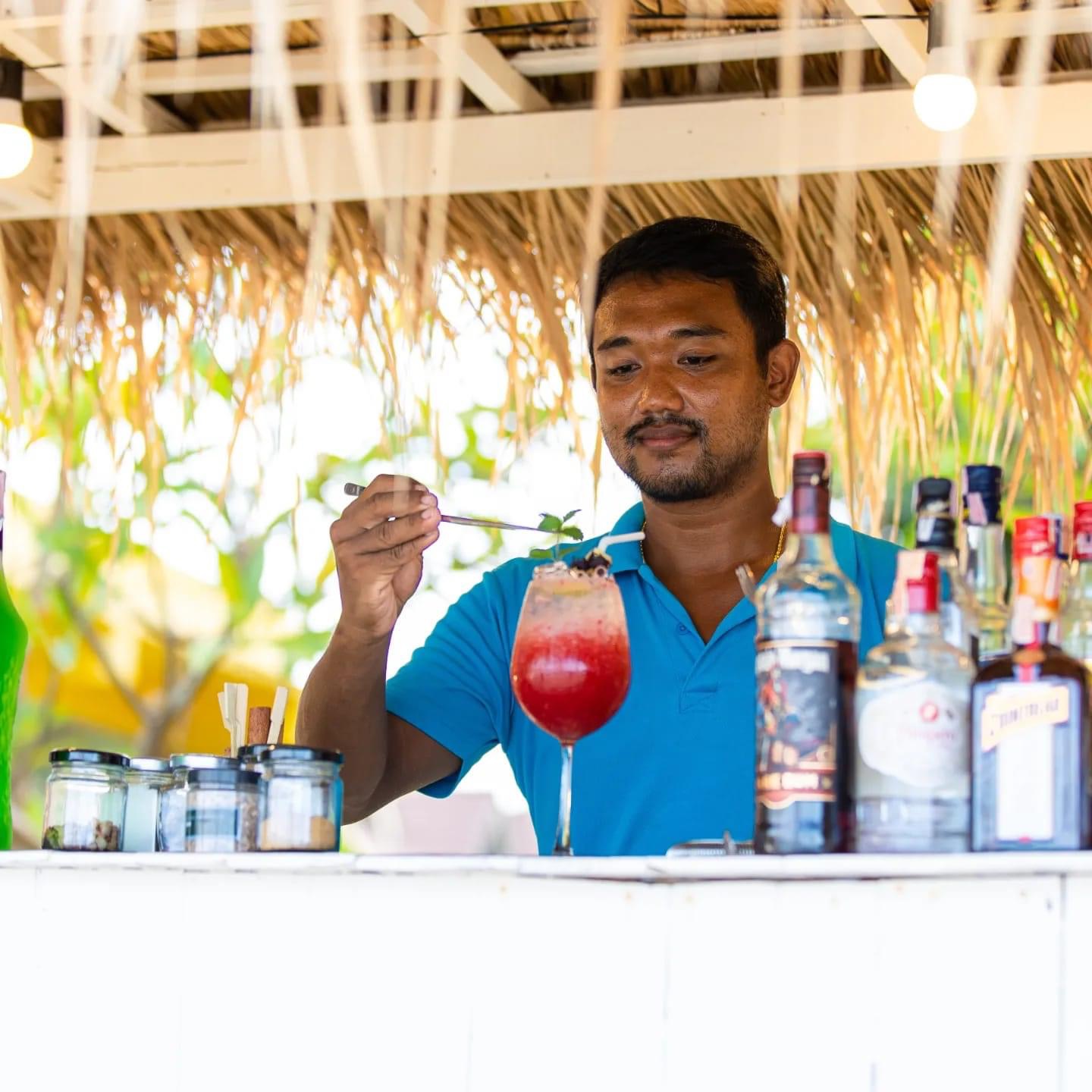 Bartender crafting a signature cocktail at The Blue Spice beach bar, Choeng Mon Beach