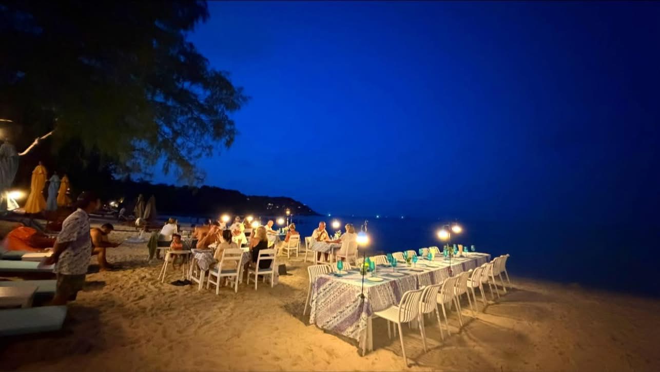 Guests dining under the night sky