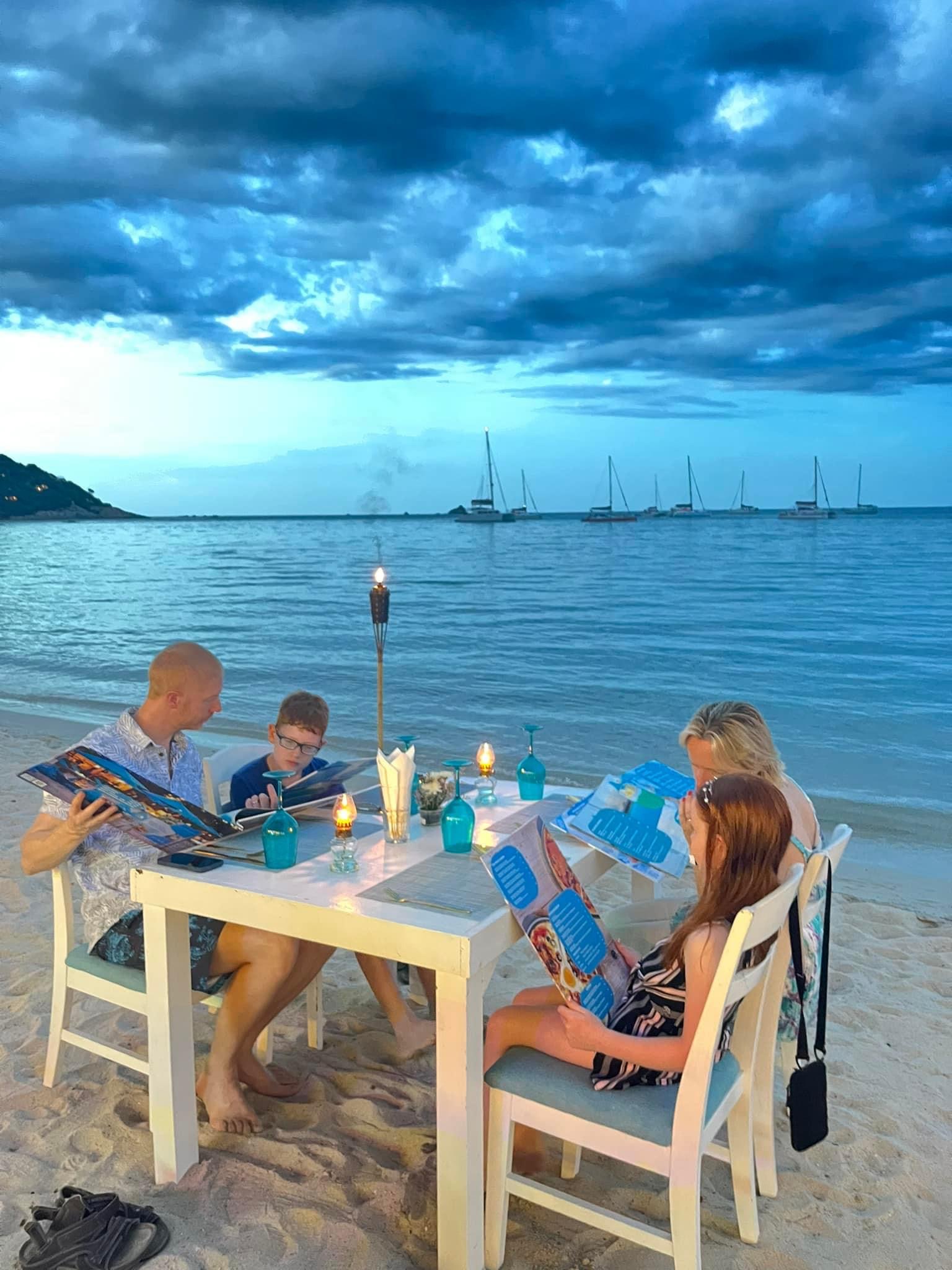 Family dining on the beach at The Blue Spice, Choeng Mon