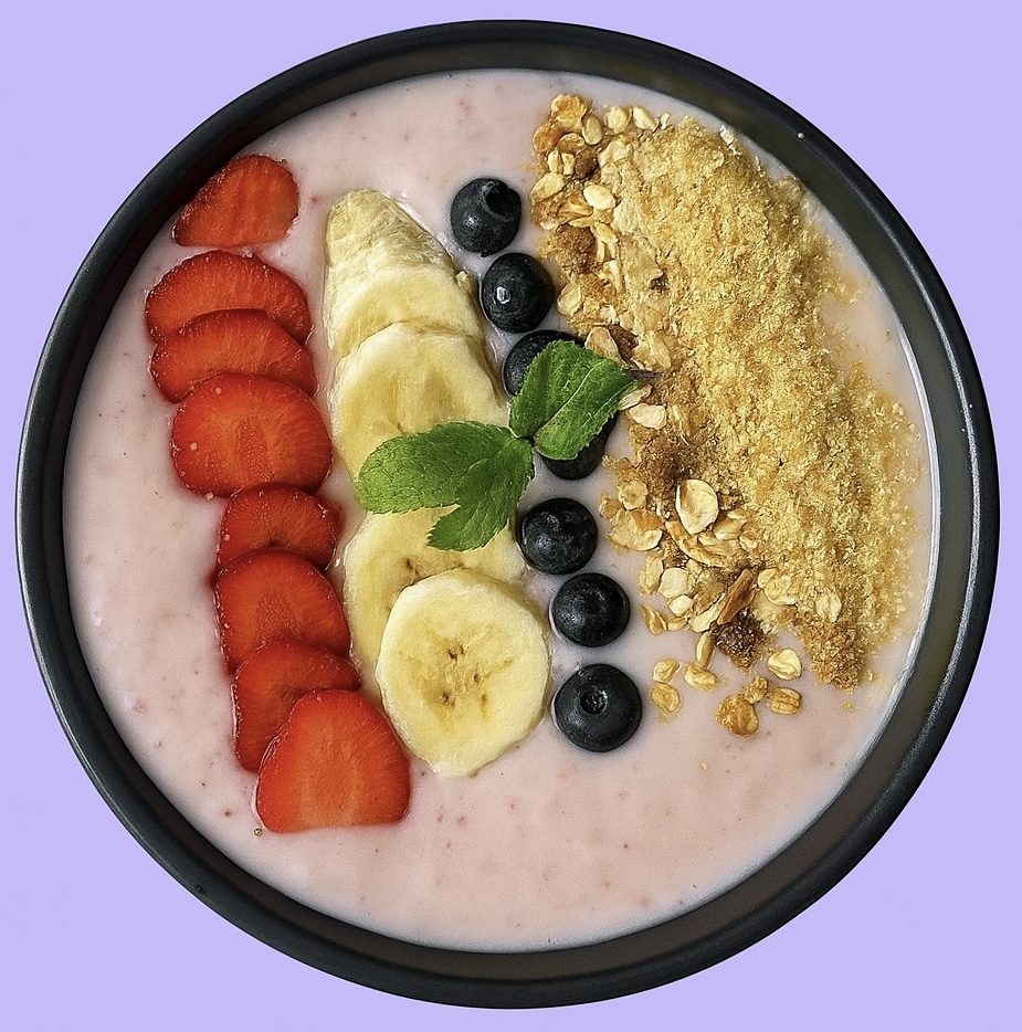Colourful smoothie bowl with strawberries, banana, blueberry and granola