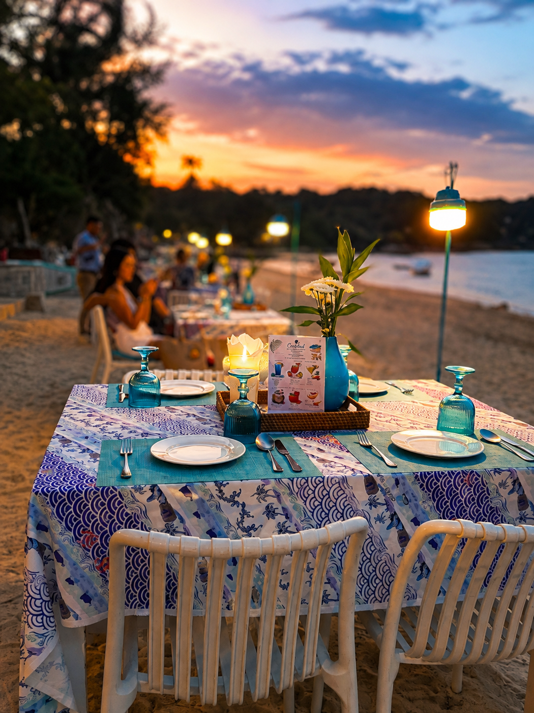 Empty table set for two on Choeng Mon Beach at dusk