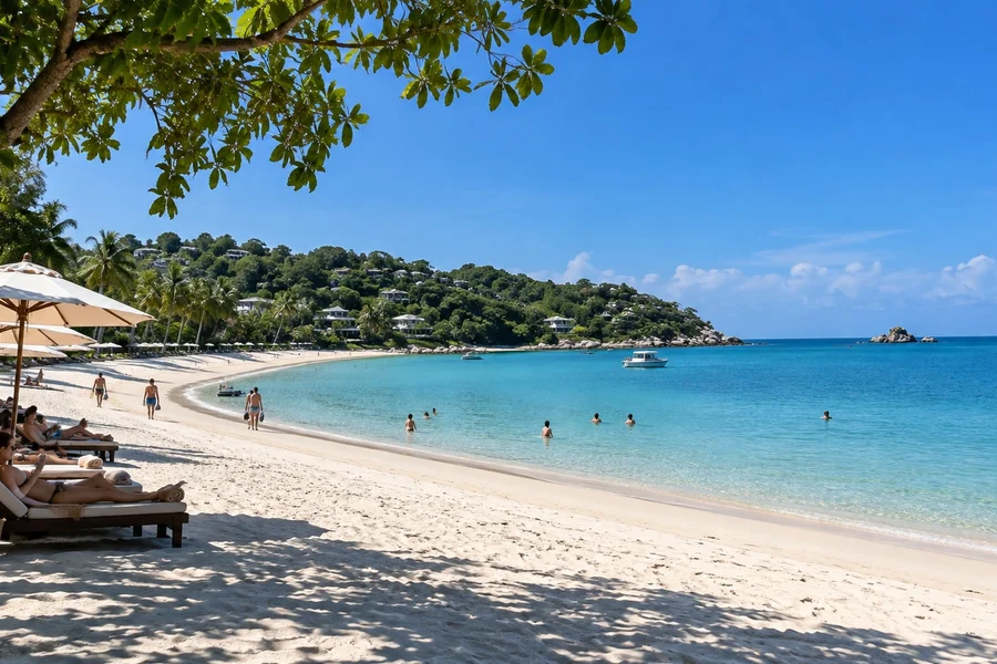 Sandy shoreline and calm turquoise water at Choeng Mon Bay