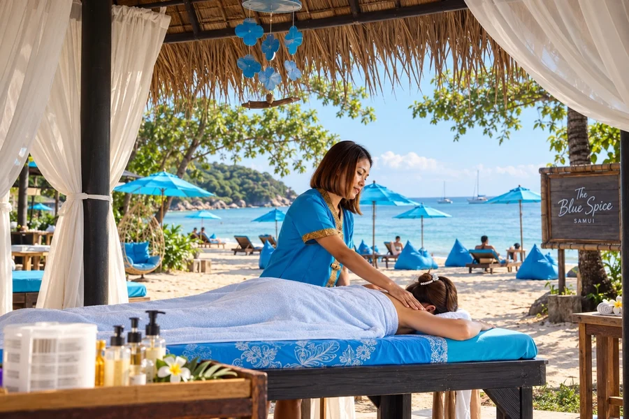 Massage therapist treating a guest in a beachside cabana at The Blue Spice